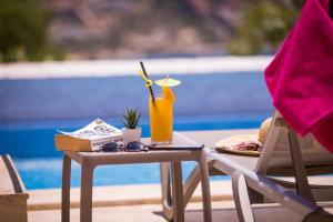a table with a vase on it next to a pool at Kalkan Saray Suites Hotel in Kalkan
