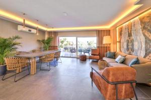 a living room with a couch and a table and chairs at Kalkan Saray Suites Hotel in Kalkan