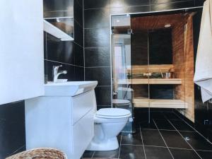 a bathroom with a toilet and a sink and a shower at Room, central location in Halmstad