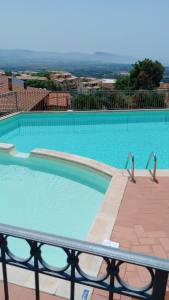 a large swimming pool with blue water at Villa La Minda with a stunning view in Badesi