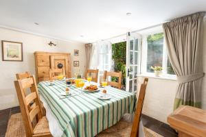 a dining room table with a plate of food on it at The Oval in Dunster