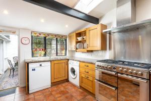 a kitchen with a stove and a dishwasher at The Oval in Dunster