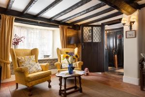 a living room with two chairs and a table at The Oval in Dunster