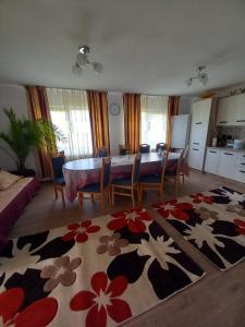 a living room with a dining room table and a kitchen at CASA LAVINIA CRASNA GORJ in Crasna