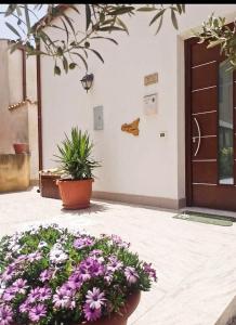 a bunch of flowers in front of a door at Al Profumo di Zagare in Locogrande