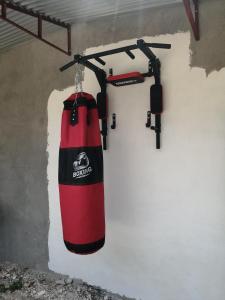 a red punching bag hanging from a wall at Bluewaves Apartment in Dauis