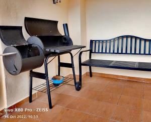 a bbq grill and a bench in a room at Ocean 19 Shamrock Villa Beachfront Big Group 4 Bedroom 5 Bathroom in Tanjung Bungah