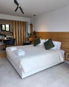 a bedroom with a large white bed in a room at Terrazza Suites in Paphos City