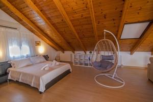 1 dormitorio con 1 cama y 1 silla mecedora en Κτήμα Ζιάκος, en Mesolongi