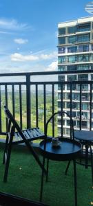 a balcony with a table and chairs and a building at MOLEK REGENCY TAMAN MOLEK in Johor Bahru