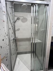 a shower with a glass door in a bathroom at Deauville: superbe appartement in Deauville