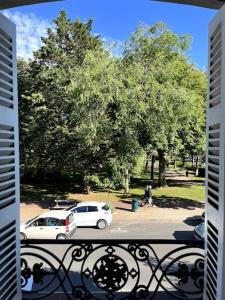 a balcony with two cars parked in a park at Deauville: superbe appartement in Deauville