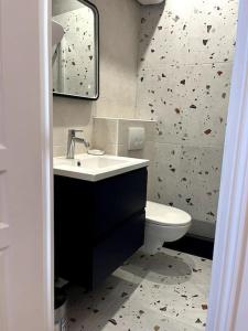 a bathroom with a sink and a toilet at Deauville: superbe appartement in Deauville