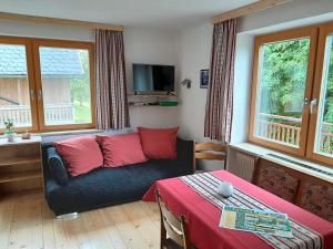 a living room with a couch and a table at Bauernhof Waira in Yspertal