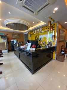a person sitting at a counter in a restaurant at GM Hotel in Changlun