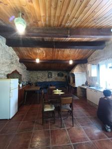 a kitchen and dining room with wooden ceilings and a table at SANTA LUCIA AREAS in Pontevedra