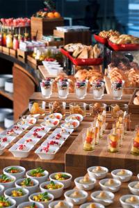 a buffet line with appetizers and bowls of food at Riyadh Diplomatic Quarter - Marriott Executive Apartments in Riyadh