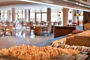 a restaurant with a bunch of food on display at Riyadh Diplomatic Quarter - Marriott Executive Apartments in Riyadh