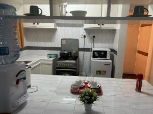 a kitchen with a table with wine glasses on it at Lux Suites Lantana Road Apartments westlands in Nairobi