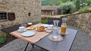 a table with food and drinks on top of it at La Corte del Chianti Classico in Gaiole in Chianti