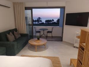 a living room with a couch and a table at Terrazza Suites in Paphos