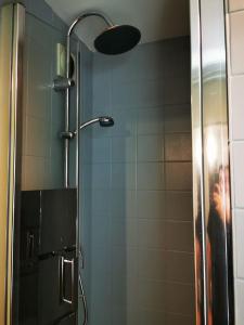 a shower with a glass door with a person taking a picture at Joli Appartement Marcq en Baroeul proche Lille in Marcq-en-Baroeul +17 photos