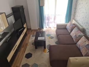 a living room with a couch and a coffee table at Stefania Apartment Sibiu in Şelimbăr