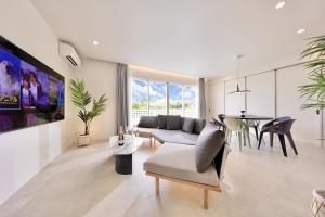 a living room with a couch and a table at Crystal Villa Bayside in Miyako Island