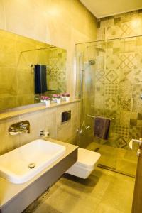 a bathroom with a sink and a shower at Exquisite 2BD at Skynest Residences with rooftop heated pool in Nairobi