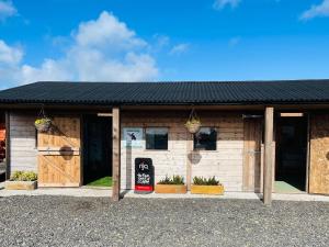 a small building with a sign in front of it at The Dairy Cottage in Newton Stewart