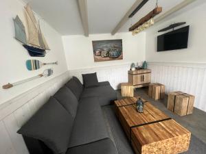 a living room with a couch and a table at Le Phare des Baleines in La Flotte