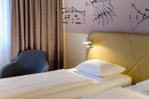 Postel nebo postele na pokoji v ubytování Mercure Hotel Berlin City