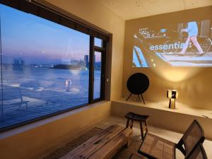 a room with a large window with a large screen at Banwol Poolvilla in Busan
