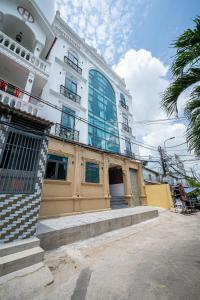 a building with a staircase in front of it at Cozrum Homes - Cozytel Residence in Ho Chi Minh City