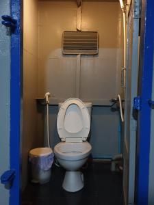 a bathroom with a toilet with the lid up at Chumphon - Koh Tao Night Ferry in Chumphon