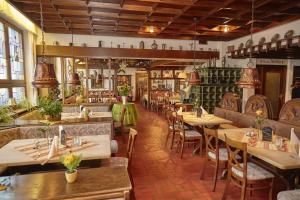 a restaurant with tables and chairs in a room at Flair Hotel Weinstube Lochner in Bad Mergentheim