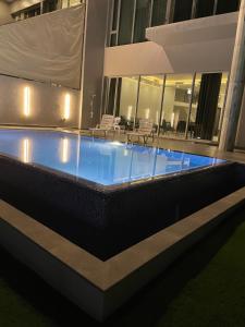 a swimming pool in the middle of a building at Sama Chalet kuwait in Al Khīrān
