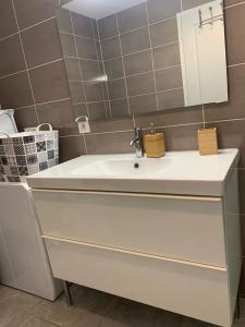 a bathroom with a white sink and a mirror at Chez Anne in La Ciotat +17 photos
