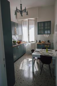 a kitchen with a table and chairs in a room at [La Terrazza di Chiavari] in Chiavari