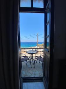 uma vista para um pátio com uma mesa e para o oceano em Belessi's Mansion em Yéfira