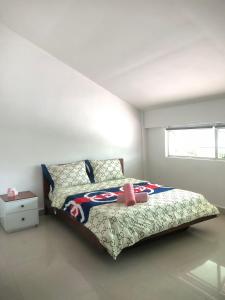a bedroom with a large bed with a baseball comforter at Yana House Phnom Penh in Phnom Penh