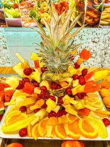 a tray of fruit with a pineapple on top of it at Arapya Resort in Arapya