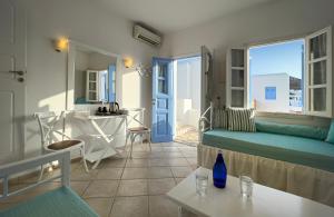 a living room with a couch and a table at Chora Resort Hotel & Spa in Chora Folegandros