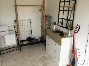 a room with a dresser and a mirror at Stubbekøbingrooms in Stubbekøbing