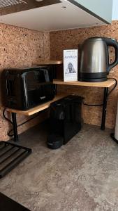 eine Mikrowelle auf einem Holzregal neben einem Tisch in der Unterkunft Hello Mountains Apartaments Sinaia in Sinaia