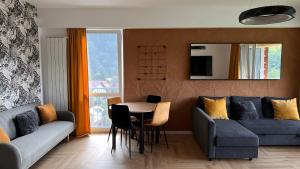 a living room with a couch and a table at Hello Mountains Apartaments Sinaia in Sinaia