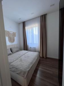 ein Schlafzimmer mit einem großen Bett und einem Fenster in der Unterkunft Villa boho in Baku