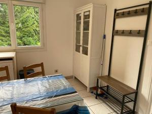 a room with a bed and a table and a window at Petite maison en Auvergne in Giat