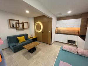 a living room with a couch and a table at Apartment ARSO in Velenje