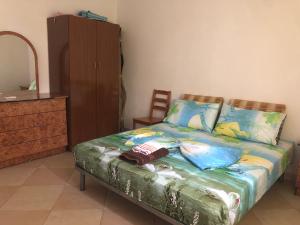 a bedroom with a bed with a dresser and a mirror at Vila Demo in Vlorë